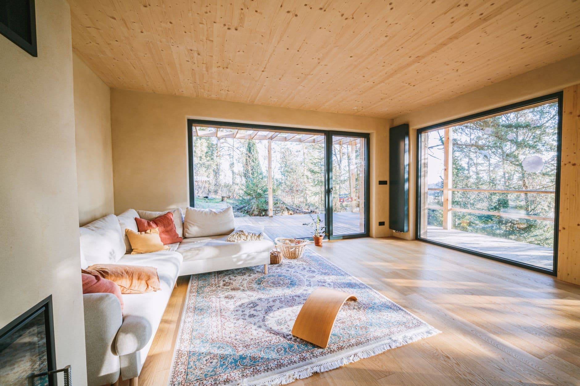 Open-plan living room with a floating staircase and floor-to-ceiling windows