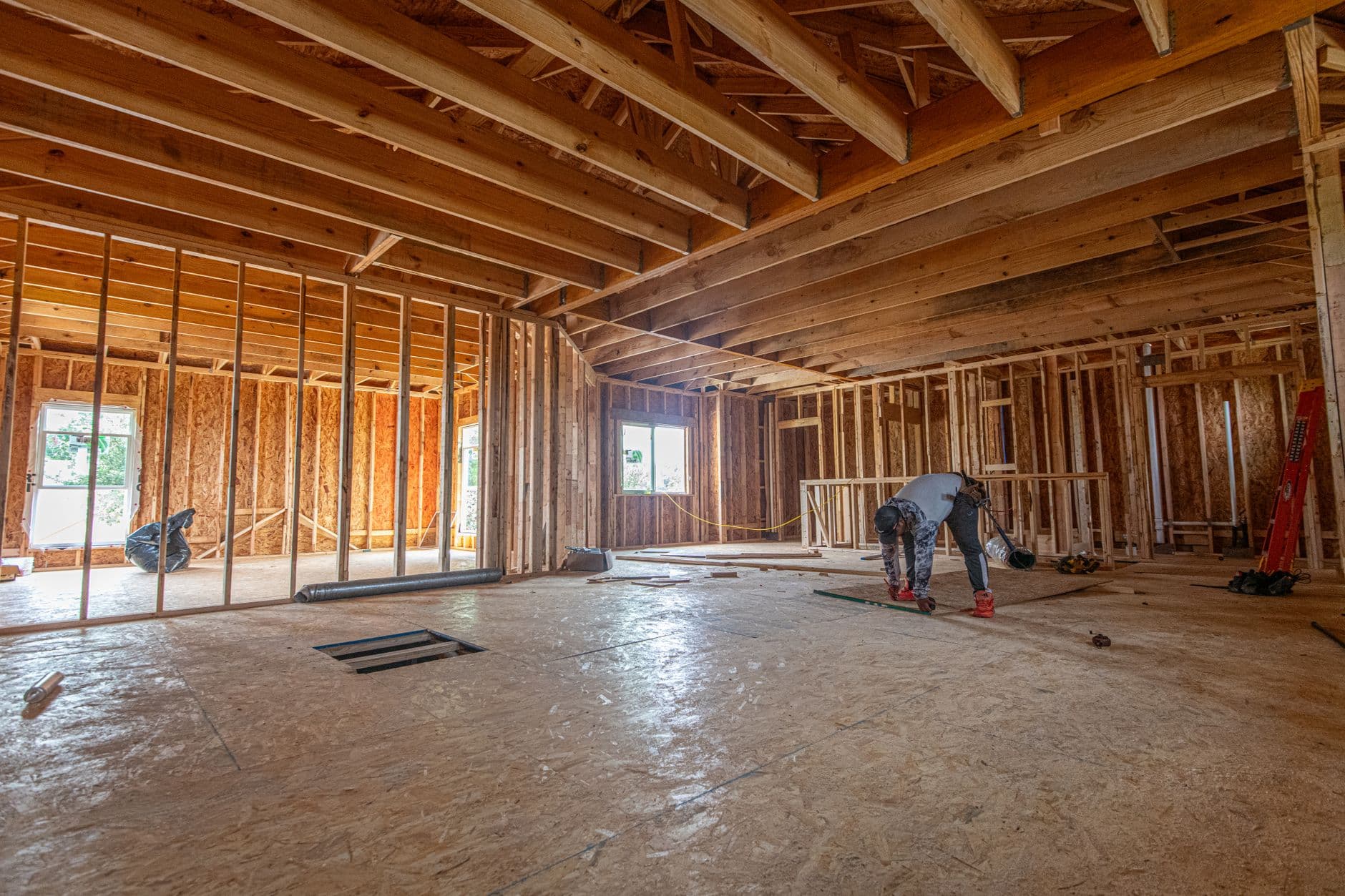 Interior of a house under construction, floor framing and stud walls exposed