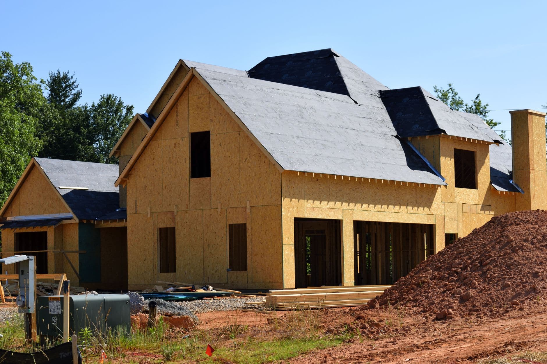 Partially built home with sheathing and roof framing complete