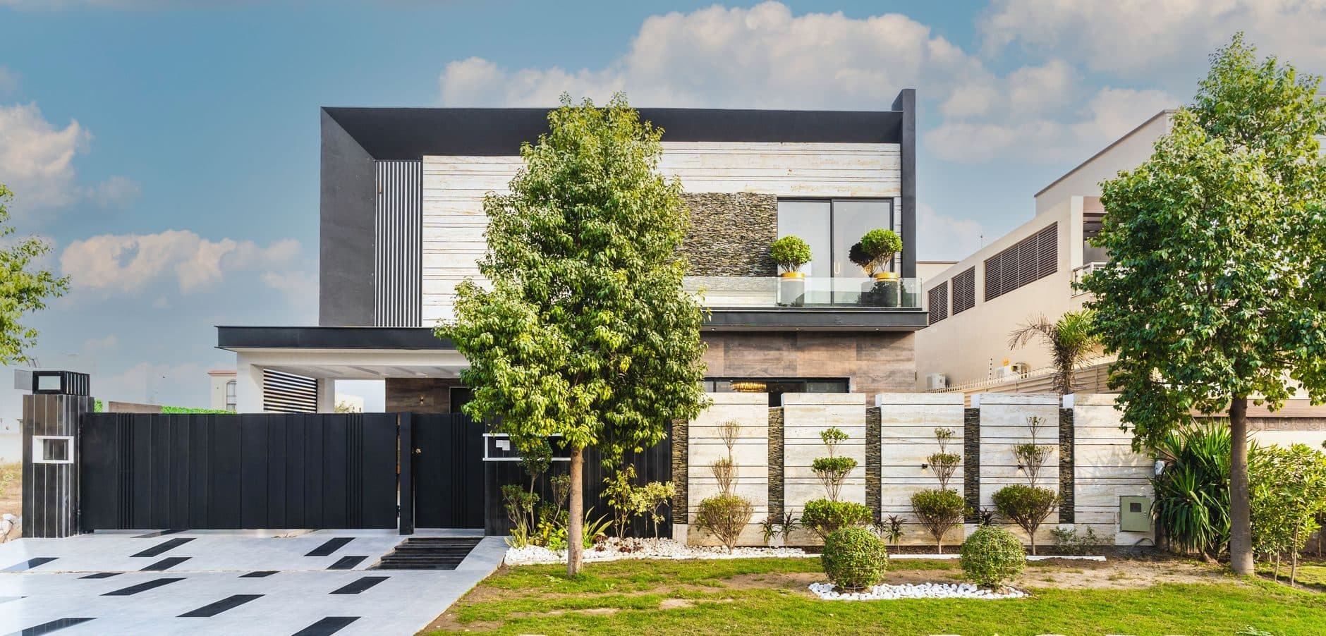 Contemporary two-storey home with a flat roof and mature landscaping in daylight
